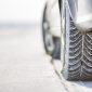 Close-up of car wheels rubber tire in deep snow. Transportation and safety concept.